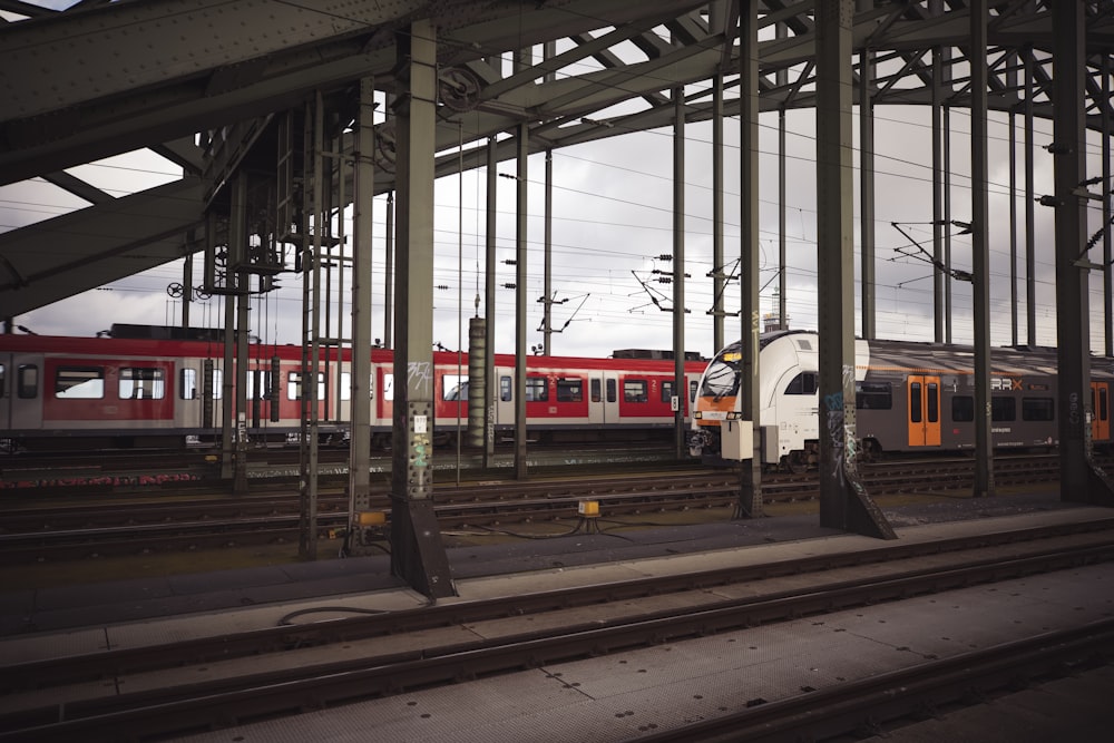 a red and white train traveling down train tracks