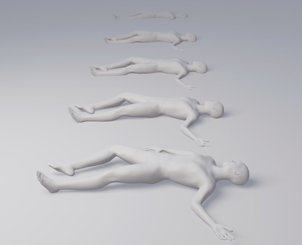 a group of white plastic figures laying on top of each other