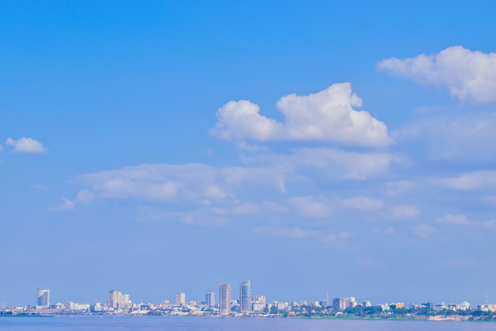 a large body of water with a city in the background