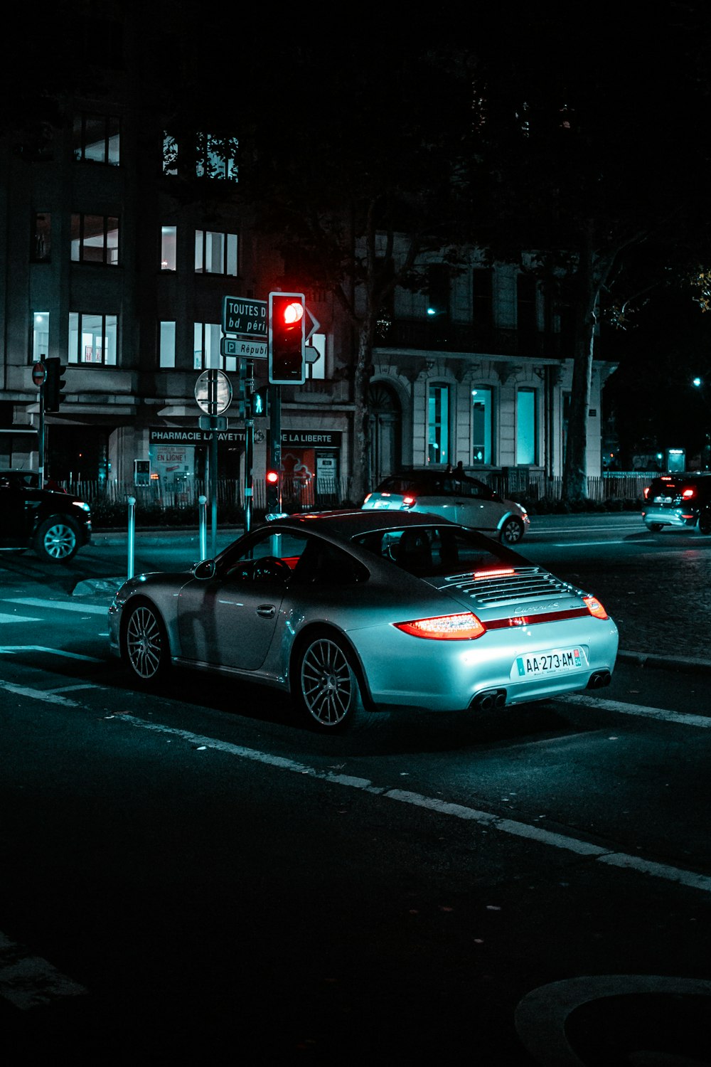 a car stopped at a red light at night