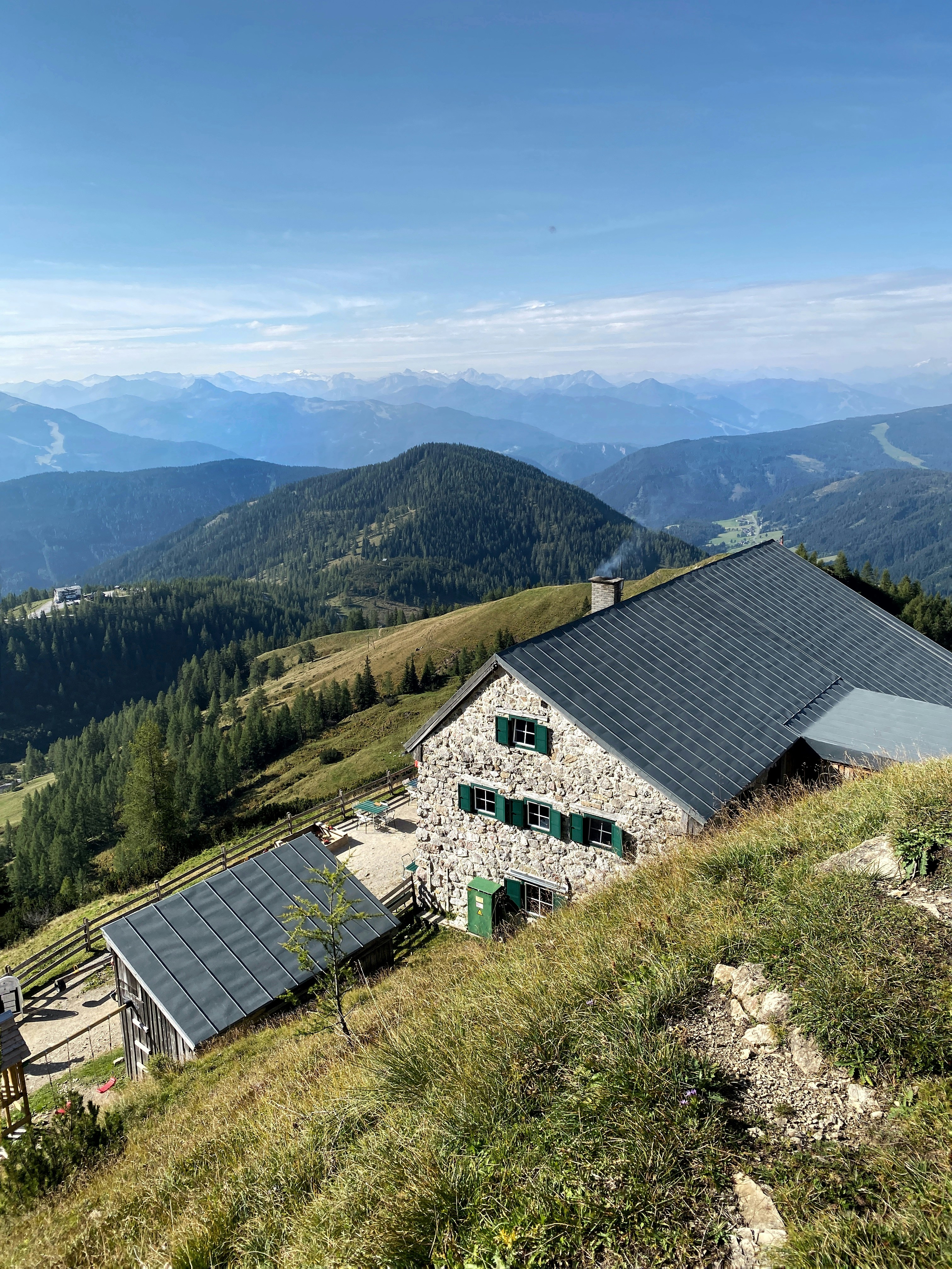 a house sitting on top of a lush green hillside