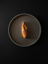 a piece of food on a plate on a table