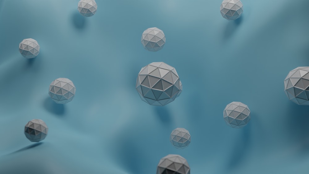 a group of white balls floating on top of a blue surface