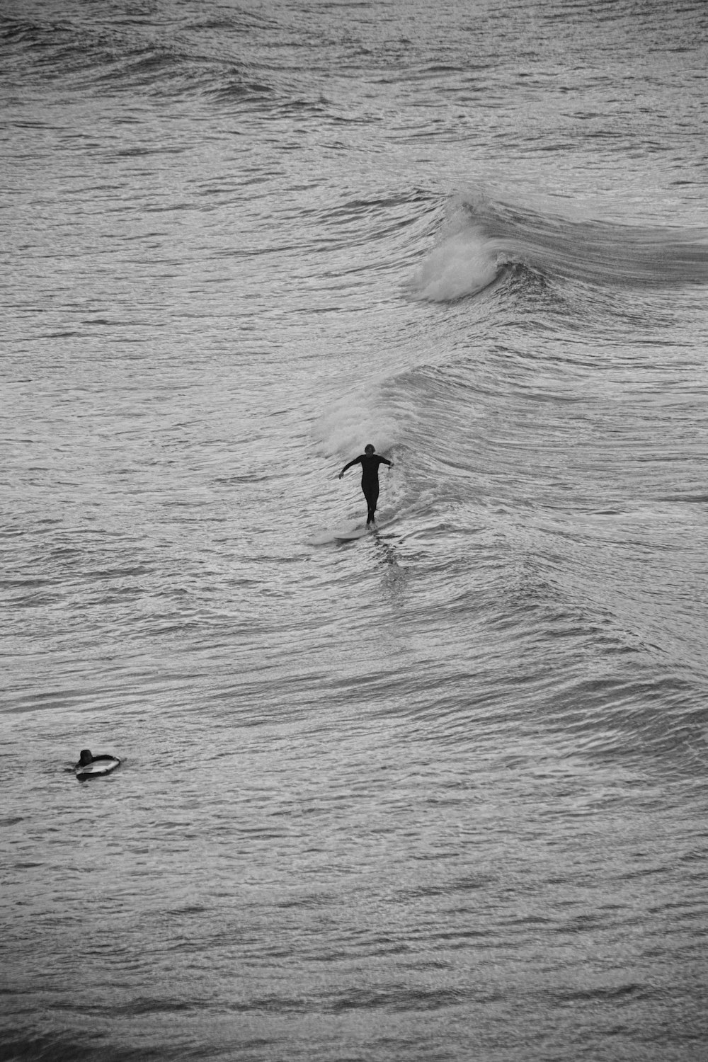 a person riding a wave on top of a surfboard