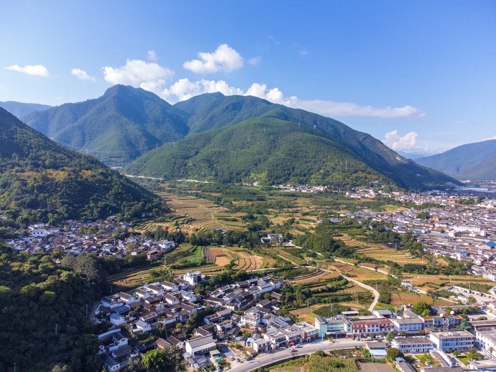 an aerial view of a town surrounded by mountains