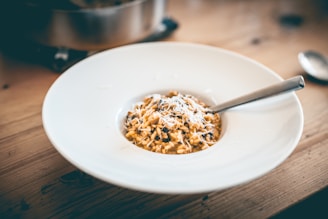 a bowl of food on a wooden table