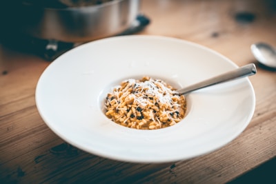 a bowl of food on a wooden table