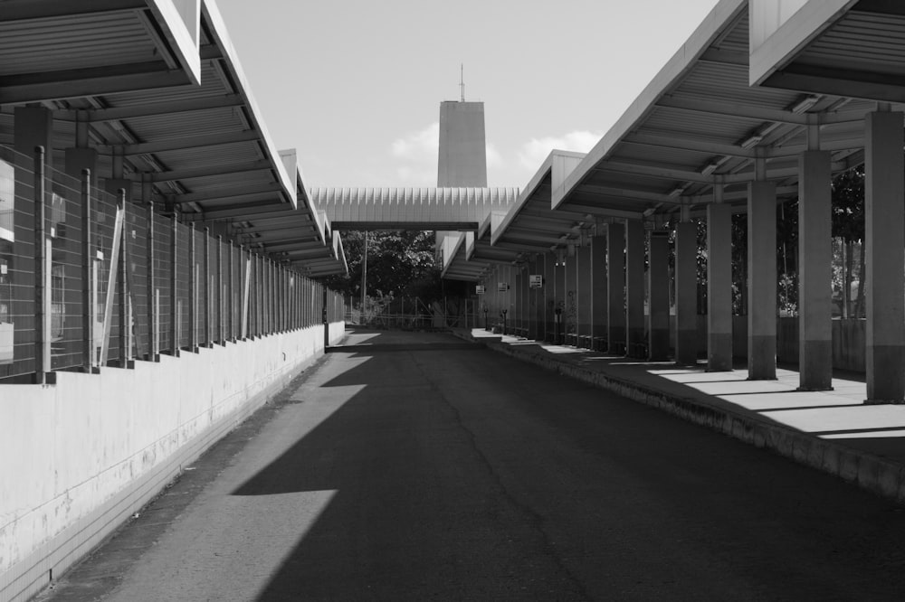 a black and white photo of a street with a building in the background