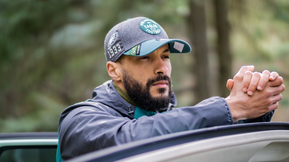 Un homme assis dans une voiture avec les mains jointes