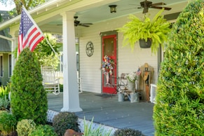 a porch with a flag on the front of it