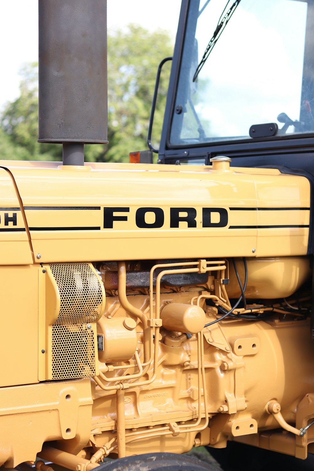 a close up of the front of a yellow tractor
