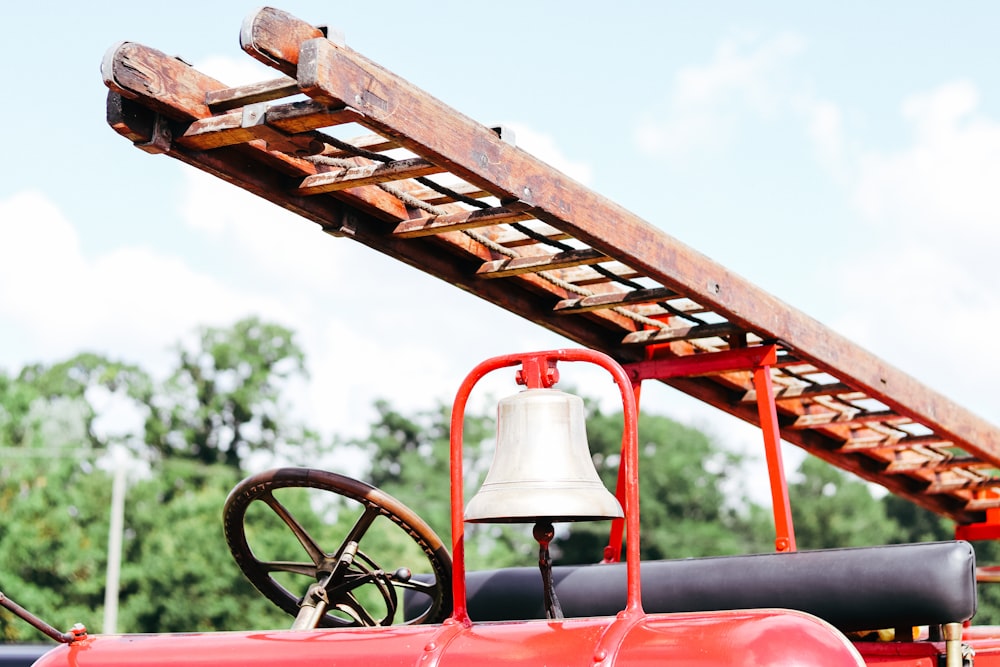 a red truck with a bell on top of it