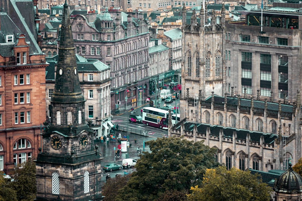 a city with lots of tall buildings and a double decker bus