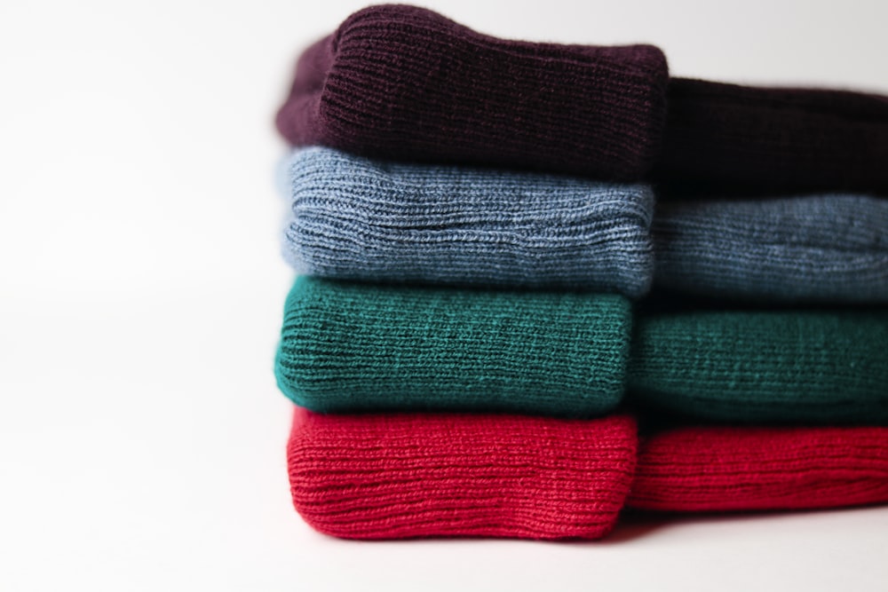 a stack of folded sweaters sitting on top of each other