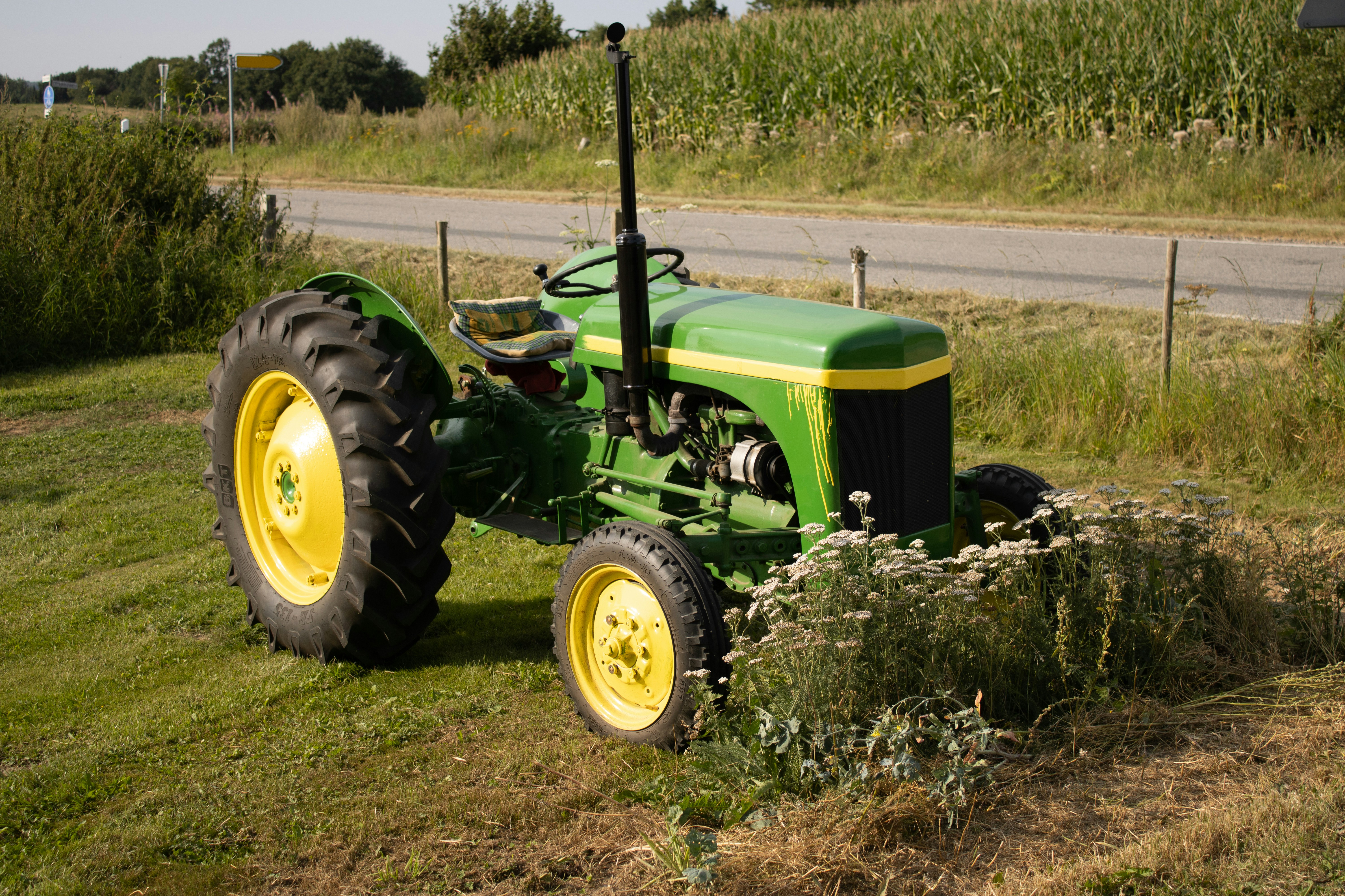 a tractor parked in a field next to a road
