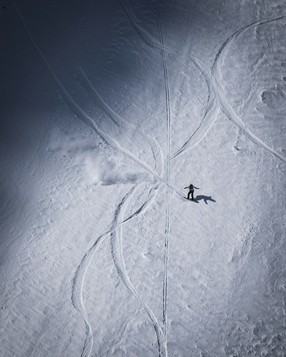 a person riding skis down a snow covered slope