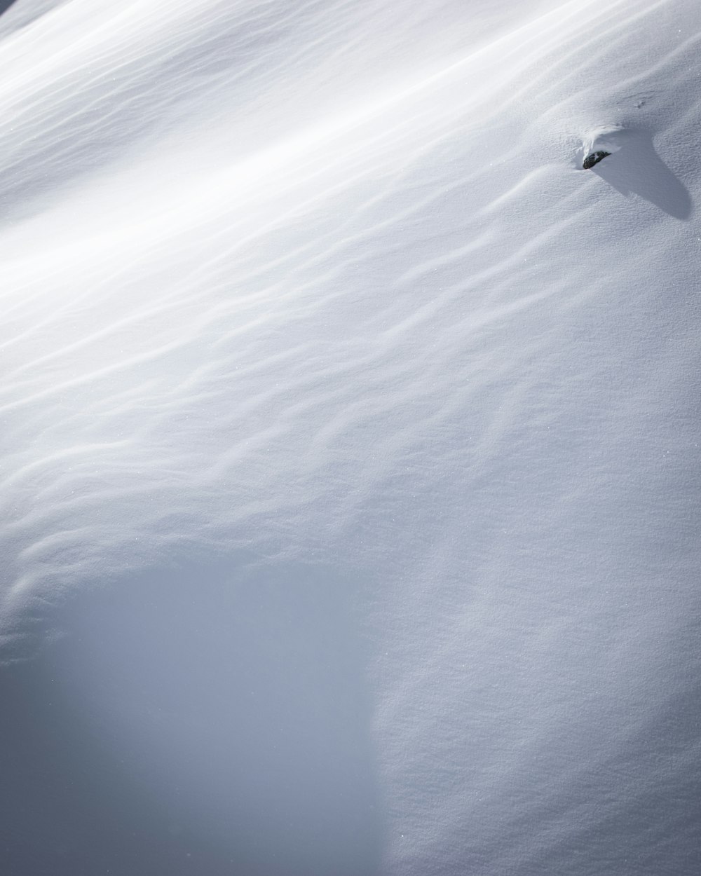 a person riding skis down a snow covered slope