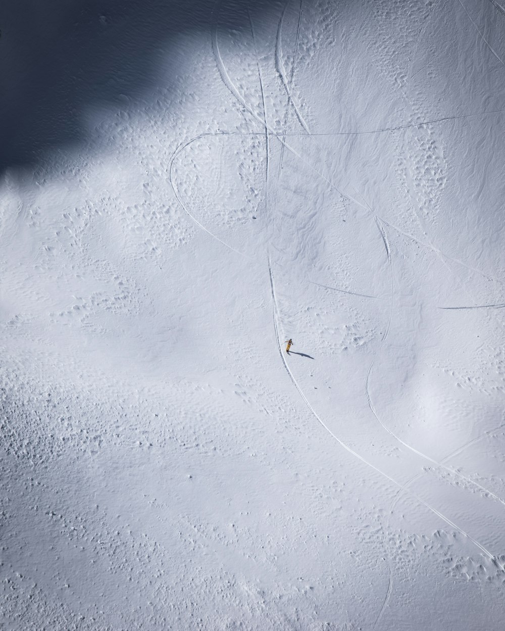 a person riding skis down a snow covered slope