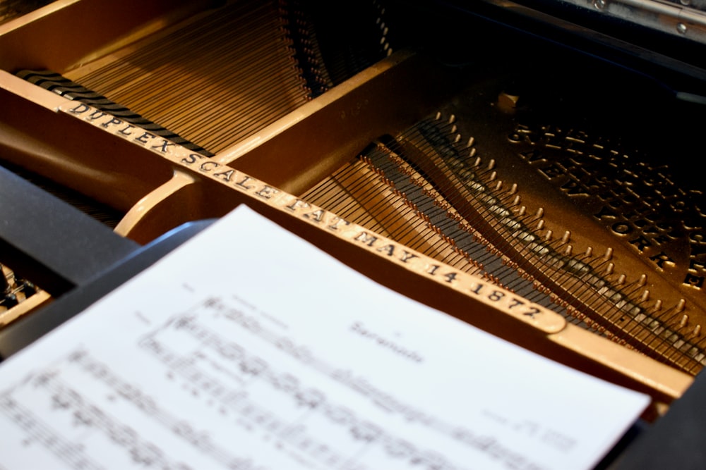 a sheet of paper sitting on top of a piano