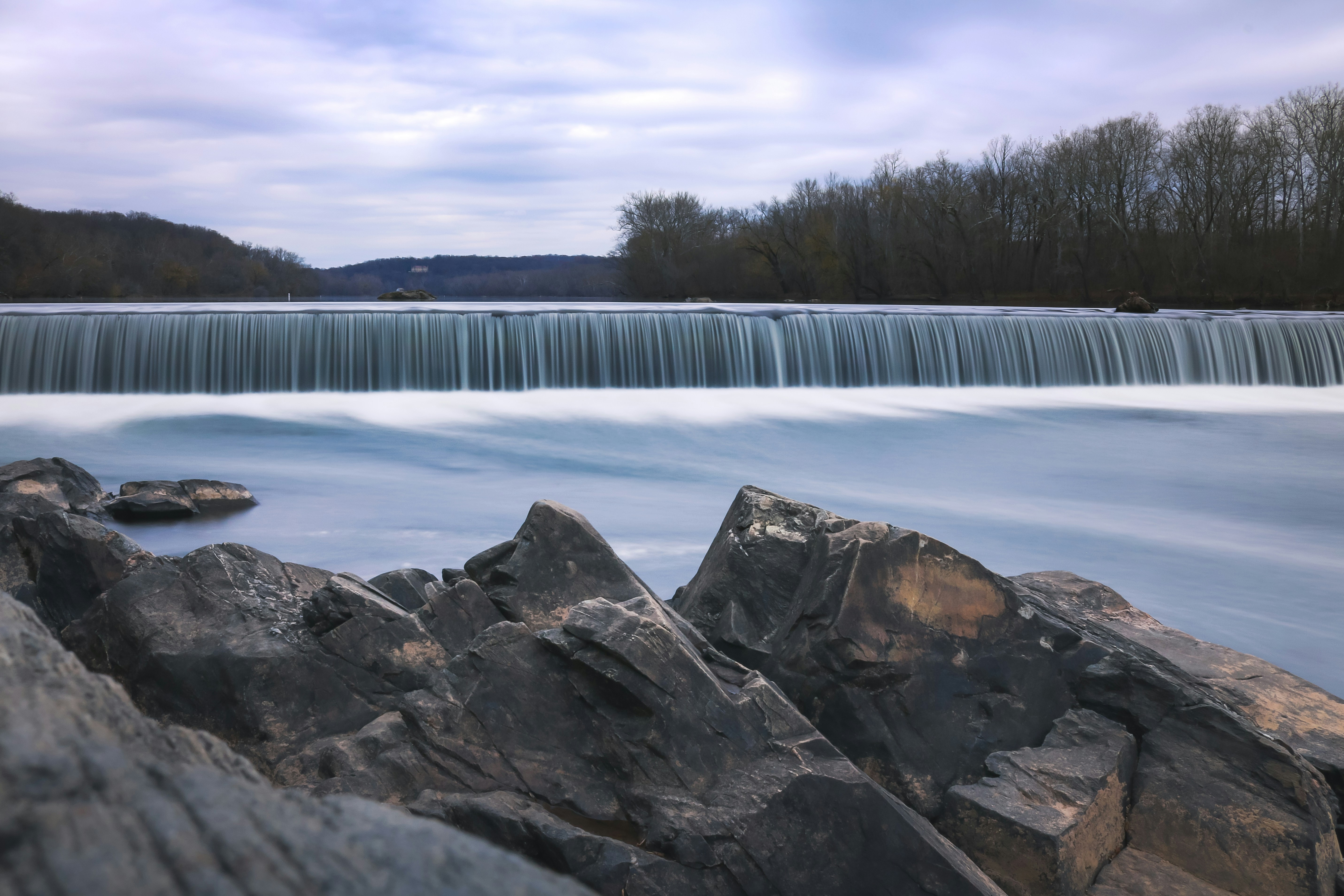 a large waterfall with a bunch of rocks in front of it