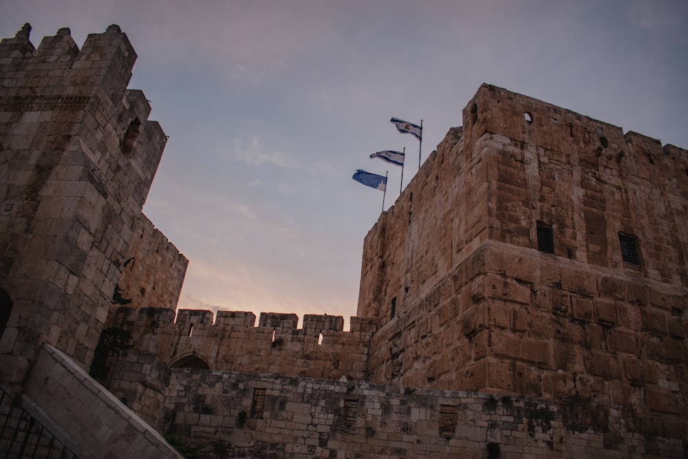 a castle with flags flying in the air