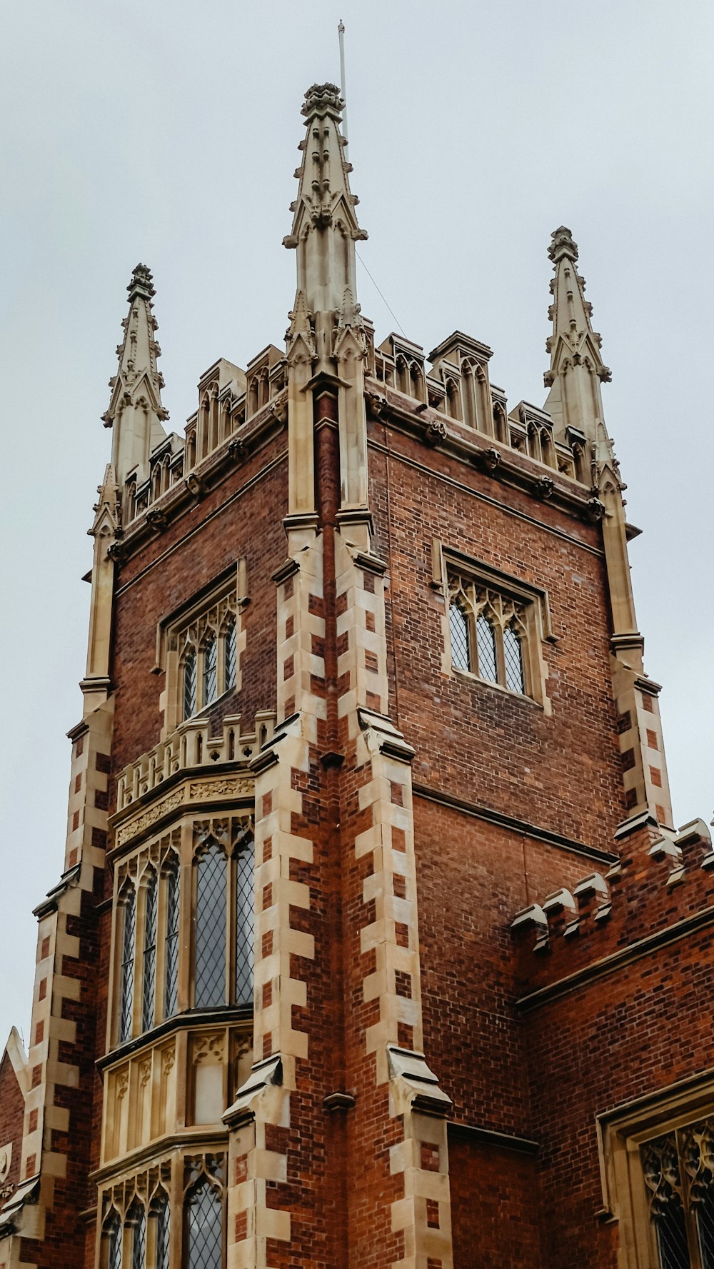 a very tall brick building with a clock on it's side