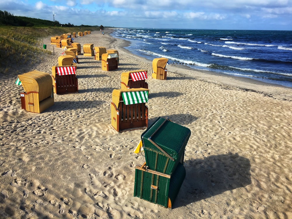 a row of beach chairs sitting on top of a sandy beach