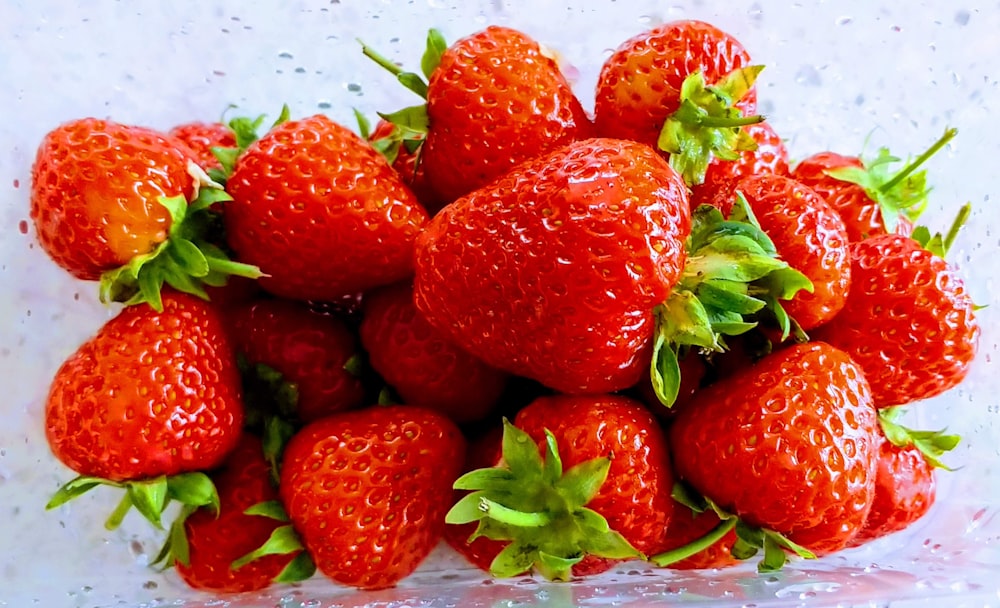 a pile of strawberries sitting on top of a table