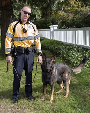 a police officer is walking his dog in the yard