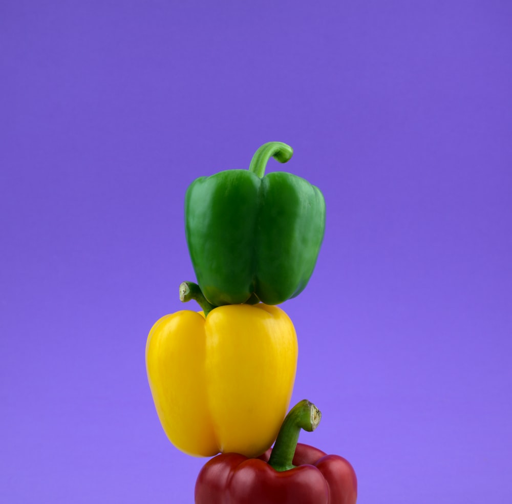 a couple of peppers sitting on top of each other