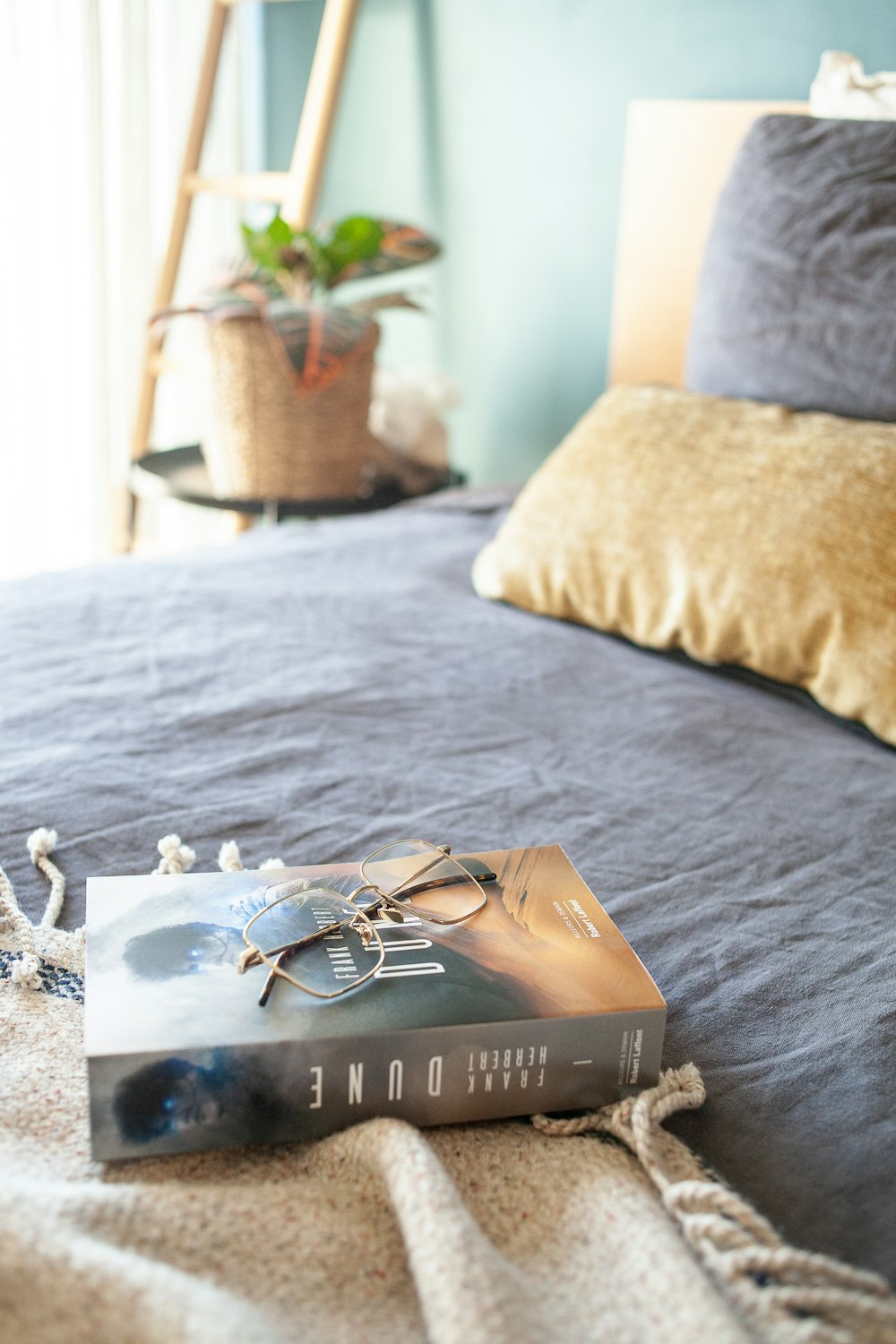a book sitting on top of a bed next to a pillow
