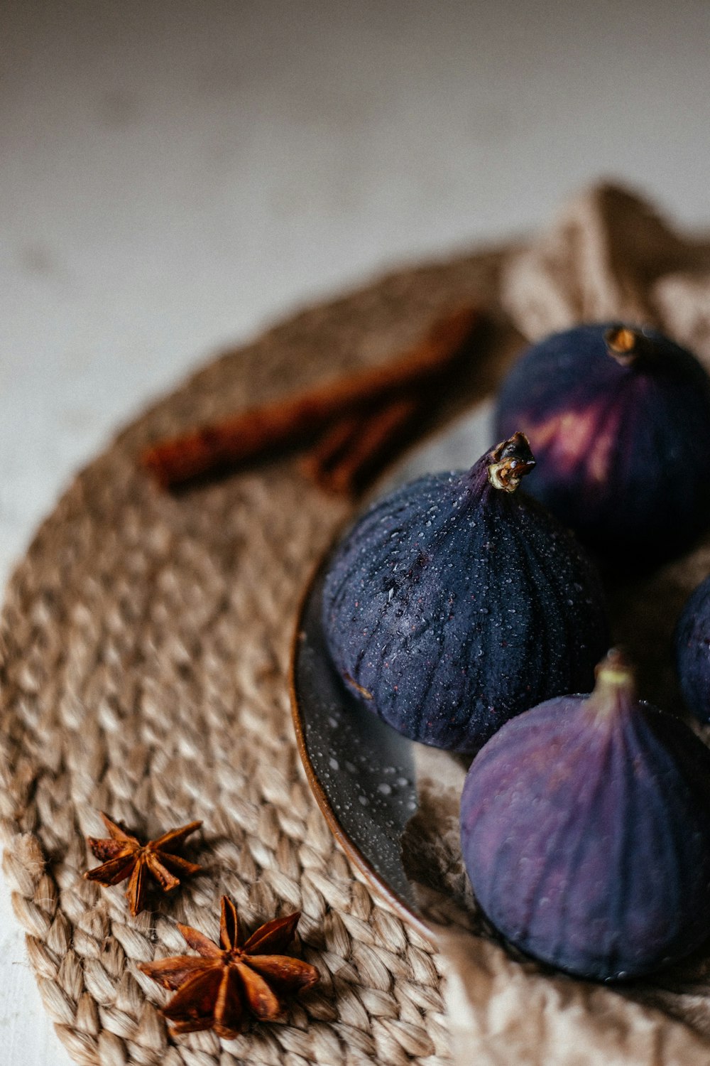 a plate topped with figs and anise on top of a table