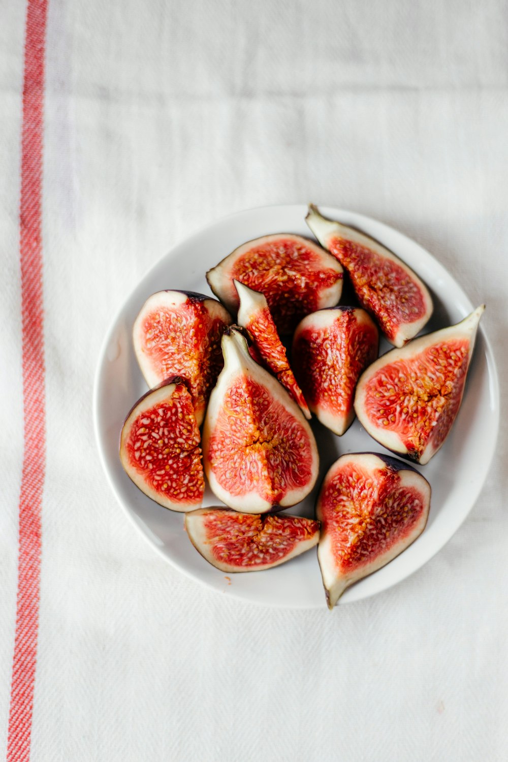 a white plate topped with cut up figs