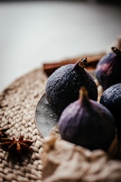 some figs are on a plate on a table