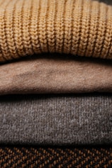 a pile of sweaters stacked on top of each other