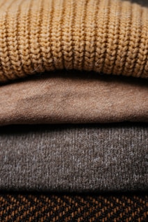 a pile of sweaters stacked on top of each other