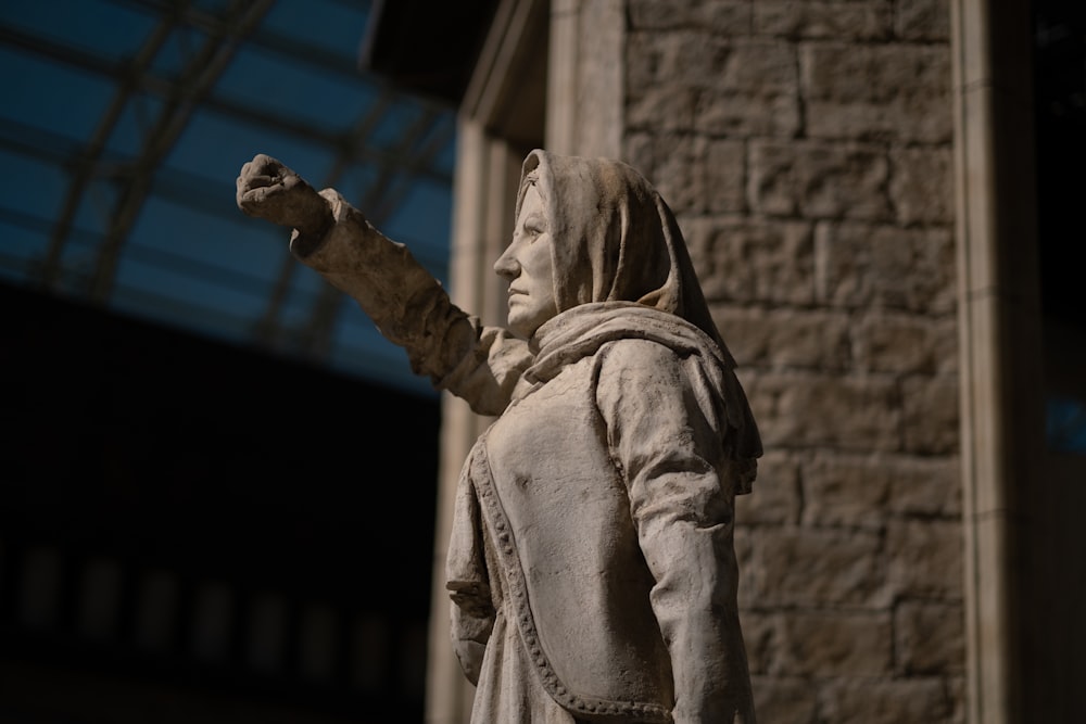 a statue of a woman holding a piece of bread