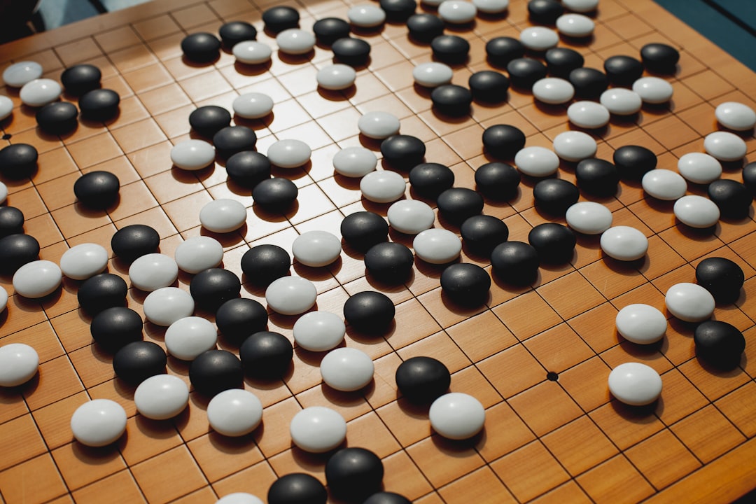 a close up of a board game with black and white balls