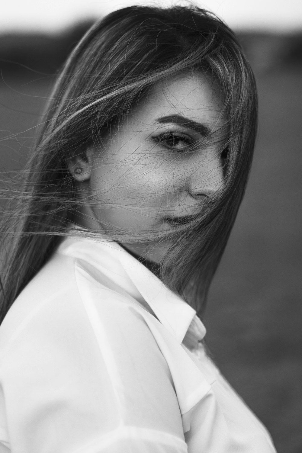 a black and white photo of a woman with long hair