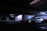 A white car parked in a parking garage
