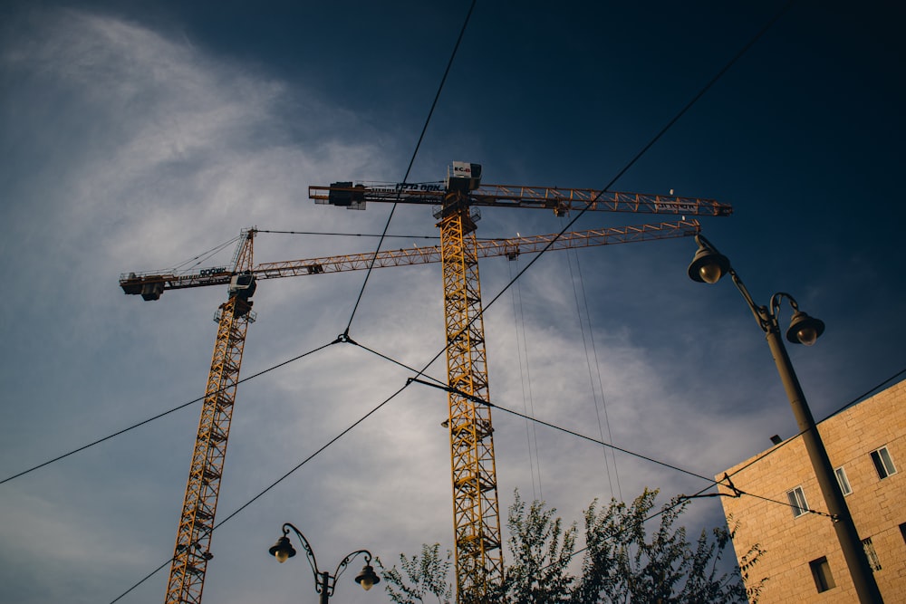 a large crane sitting next to a tall building