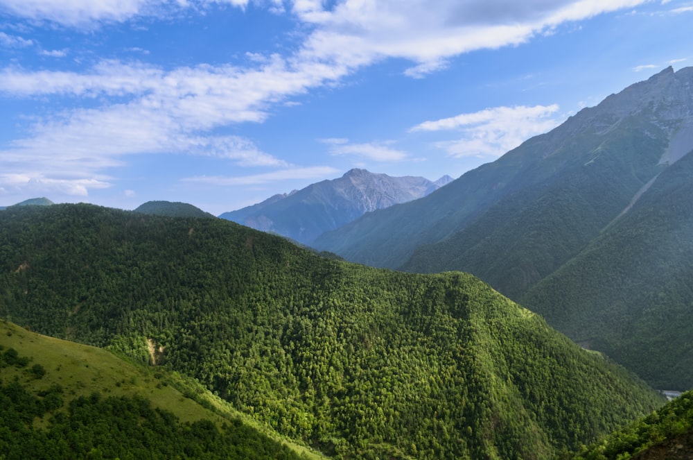 a view of a valley with mountains in the background