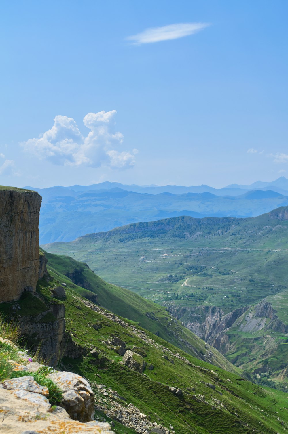 a view of a valley with mountains in the background