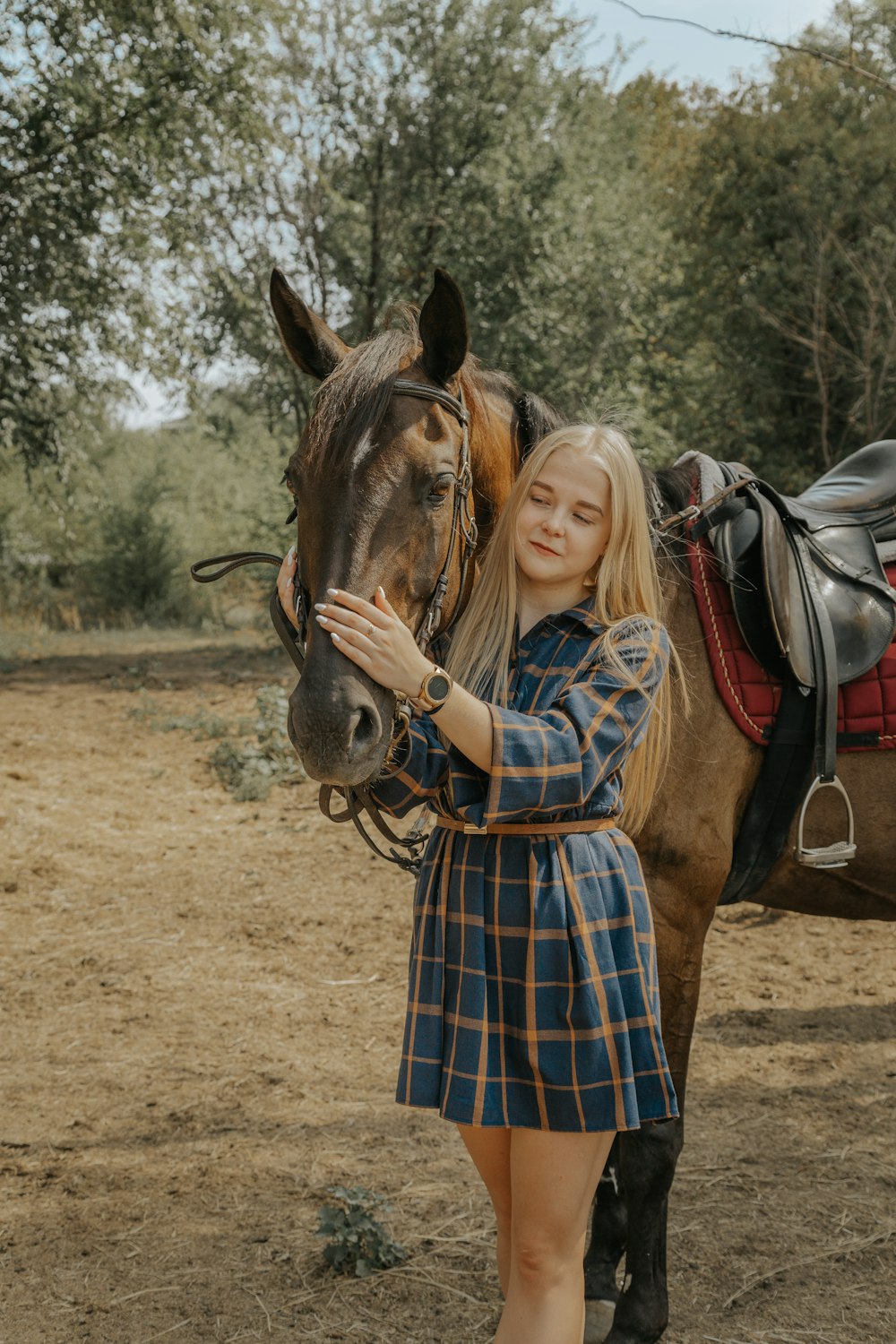 a woman is standing next to a horse