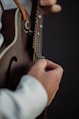 a close up of a person playing a guitar