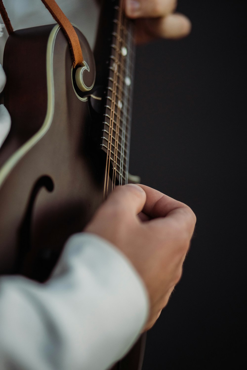 a close up of a person playing a guitar