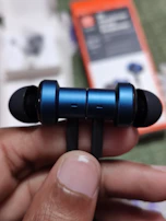 A smiling team member inspecting the latest batch of wireless earbuds, emphasizing quality and care.