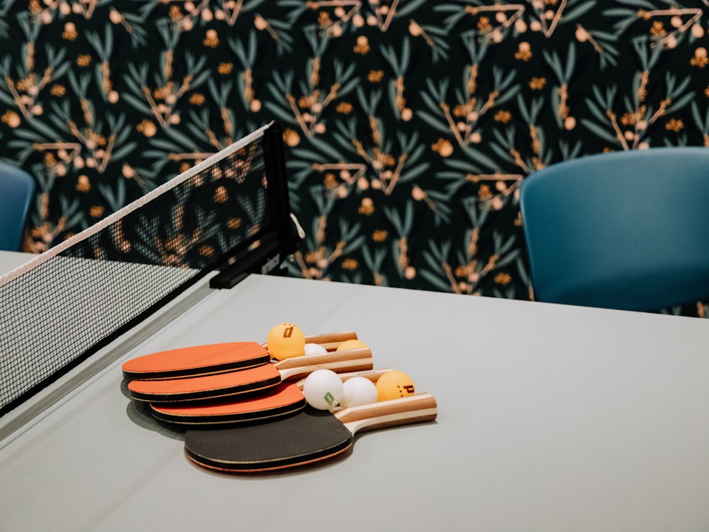 a ping pong table with ping pong paddles and ping pong balls