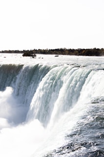 a large waterfall over some water