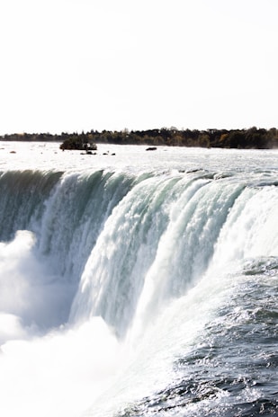 a large waterfall over some water